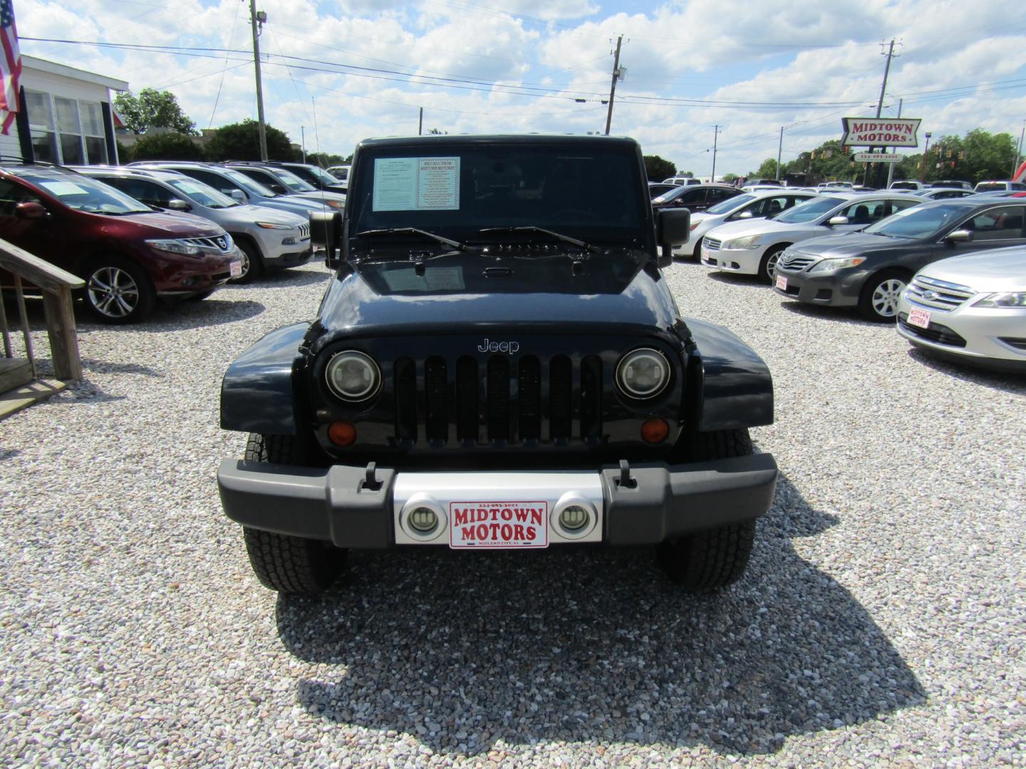 2012 Black /Tan Jeep Wrangler Sahara 4WD (1C4GJWBG2CL) with an 3.6L V6 DOHC 24V FFV engine, Automatic transmission, located at 15016 S Hwy 231, Midland City, AL, 36350, (334) 983-3001, 31.306210, -85.495277 - Photo#1